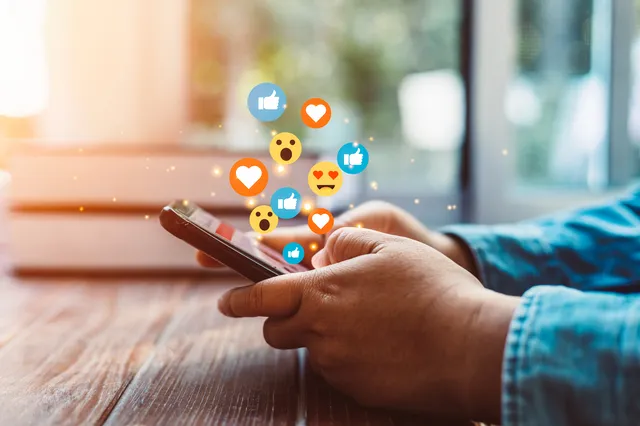 Man using phone with social media icons